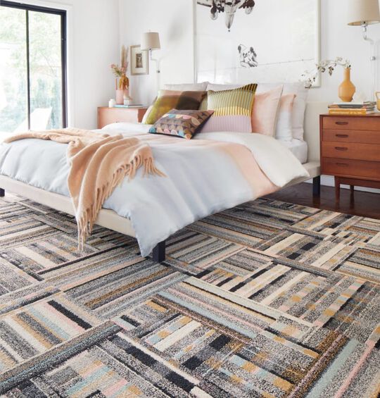 Bedroom area rug shot showing FLOR Better Half in Blush